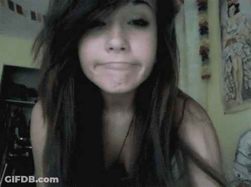 A Girl With Long Hair Making A Funny Face In A Room GIF