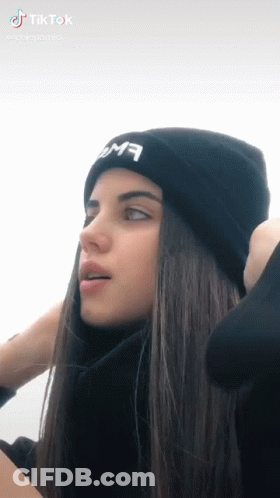 A Girl With Long Hair Wearing A Black Beanie GIF