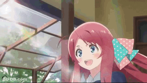 A Girl With Long Pink Hair And A Bow In Her Hair Is Smiling . GIF