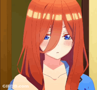 A Girl With Long Red Hair And Blue Eyes Is Standing In Front Of A Door . GIF