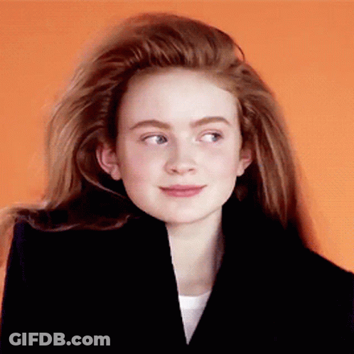 A Girl With Long Red Hair Wearing A Black Jacket GIF