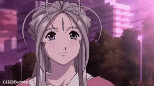 A Girl With Long White Hair And A Crown On Her Head Is Standing In Front Of A Purple Building . GIF