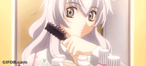 A Girl With Long White Hair Is Brushing Her Hair In Front Of A Mirror GIF