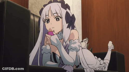 A Girl With Long White Hair Is Laying On A Couch With Her Legs Crossed GIF