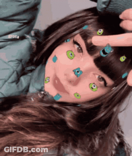 A Girl With Monsters On Her Face Is Being Touched By Someone GIF