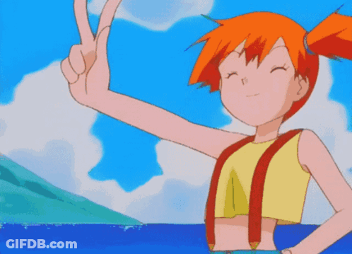 A Girl With Orange Hair Is Giving A Peace Sign In Front Of The Ocean GIF