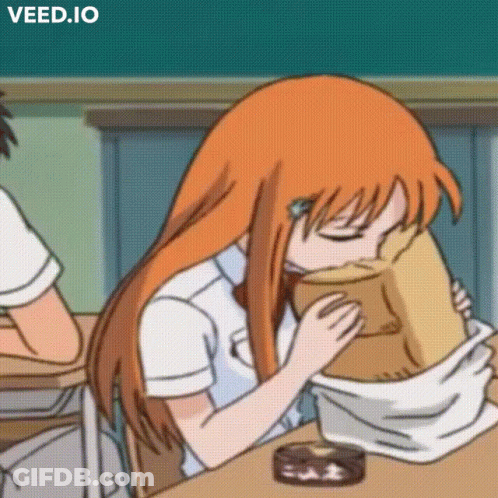 A Girl With Orange Hair Is Sitting At A Desk With Her Eyes Closed And A Bag On Her Head .. GIF