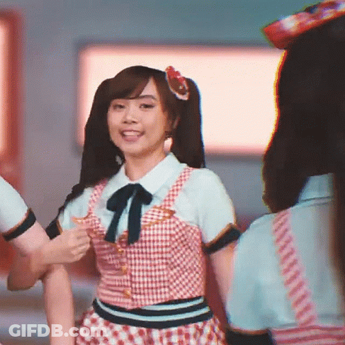 A Girl With Pigtails And A Flower In Her Hair Is Dancing GIF