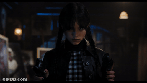 A Girl With Pigtails Is Holding A Gun GIF