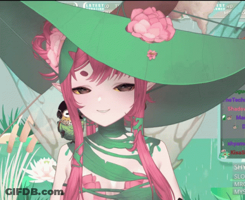 A Girl With Pink Hair And A Green Hat Is Smiling GIF