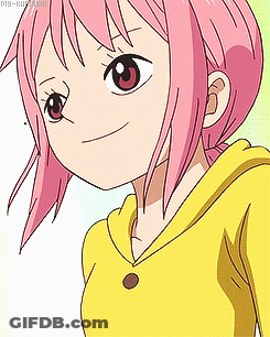 A Girl With Pink Hair And A Yellow Shirt Is Smiling GIF
