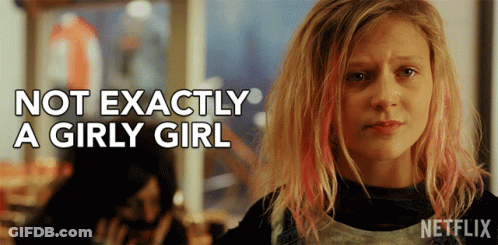 A Girl With Pink Hair And The Words Not Exactly A Girly Girl Behind Her GIF