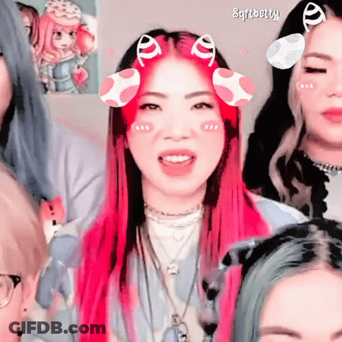 A Girl With Pink Hair Has A Sticker On Her Face That Says ' Sfitbetty ' GIF