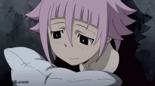 A Girl With Pink Hair Is Holding A White Pillow And Looking At The Camera . GIF