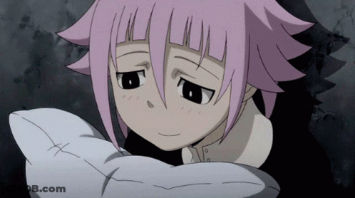 A Girl With Pink Hair Is Holding A White Pillow With A Cross On It GIF