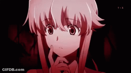 A Girl With Pink Hair Is Holding Her Hand To Her Chin In A Dark Room . GIF