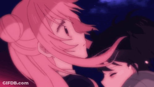 A Girl With Pink Hair Is Kissing A Boy GIF