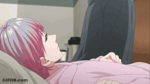 A Girl With Pink Hair Is Laying Down In A Bed GIF