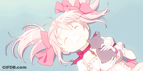 A Girl With Pink Hair Is Laying Down With A Cat GIF