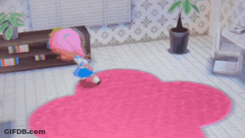 A Girl With Pink Hair Is Laying On A Pink Rug In A Room GIF