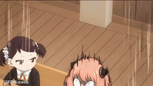 A Girl With Pink Hair Is Making A Funny Face While Another Girl Looks Angry GIF