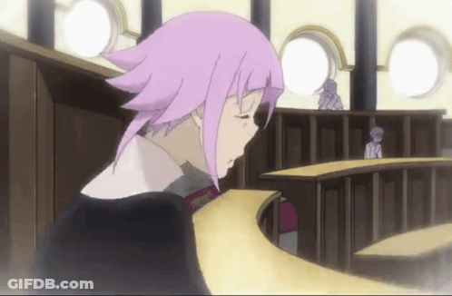 A Girl With Pink Hair Is Sitting At A Table GIF
