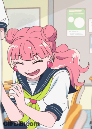 A Girl With Pink Hair Is Sitting In A Classroom And Smiling GIF