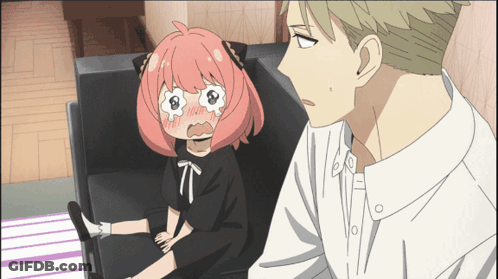A Girl With Pink Hair Is Sitting On A Couch Next To A Man In A White Shirt GIF