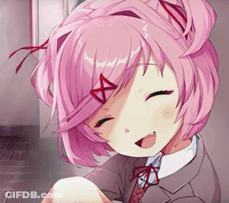 A Girl With Pink Hair Is Smiling And Holding Something GIF