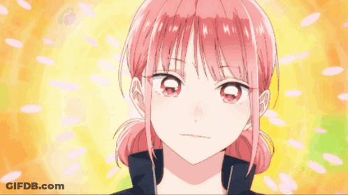 A Girl With Pink Hair Is Smiling With Her Fist Up GIF