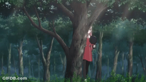 A Girl With Pink Hair Is Standing In The Woods GIF
