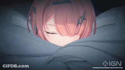 A Girl With Pink Hair Is Wrapped In A Blanket With Ign On The Bottom Right GIF