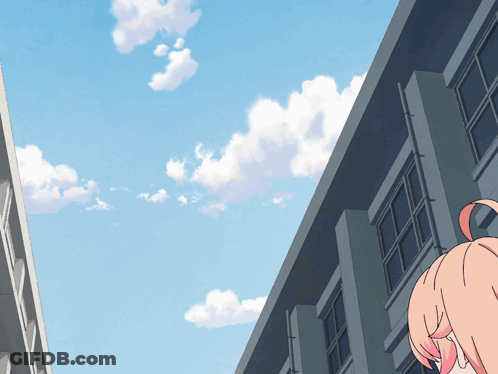 A Girl With Pink Hair Stands In Front Of A Building GIF
