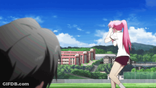A Girl With Pink Hair Stands In Front Of A School GIF