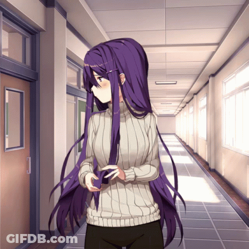 A Girl With Purple Hair Is Standing In A Hallway With A Sweater On GIF