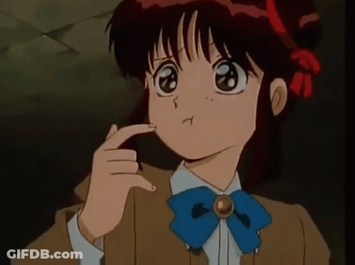 A Girl With Red Hair And A Blue Bow Tie Is Making A Funny Face . GIF