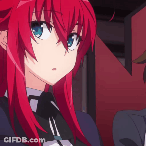 A Girl With Red Hair And Blue Eyes Is Looking At Something GIF