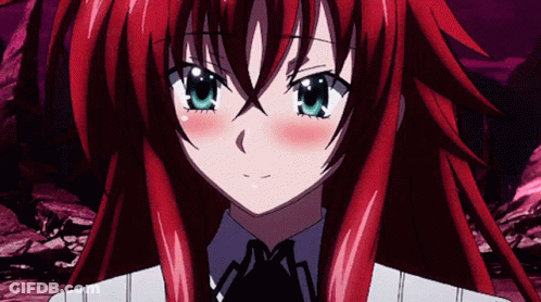 A Girl With Red Hair And Blue Eyes Is Looking At The Camera GIF