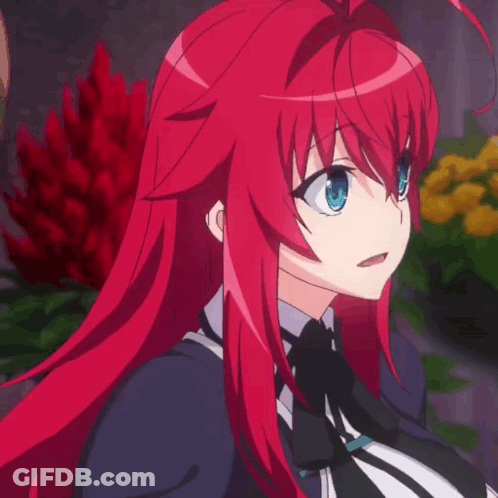 A Girl With Red Hair And Blue Eyes Is Standing In Front Of Flowers GIF