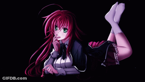A Girl With Red Hair And Green Eyes Is Laying Down With Her Legs Crossed GIF