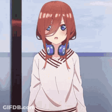 A Girl With Red Hair And Headphones Around Her Neck Is Standing In Front Of A Window . GIF