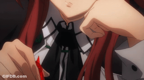 A Girl With Red Hair Is Holding A Red Object In Her Hand GIF