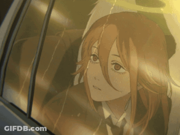 A Girl With Red Hair Is Looking Out A Car Window GIF