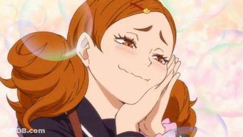 A Girl With Red Hair Is Making A Funny Face With Her Hands On Her Face GIF