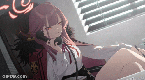 A Girl With Red Hair Is Sitting In A Chair Talking On A Telephone GIF