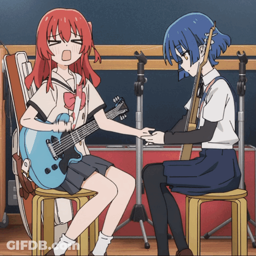 A Girl With Red Hair Is Sitting Next To A Girl With Blue Hair GIF