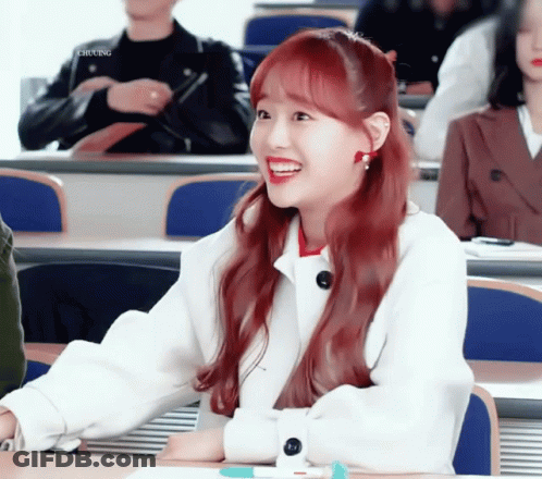 A Girl With Red Hair Is Smiling In A Classroom With Chung Written On The Bottom Left GIF