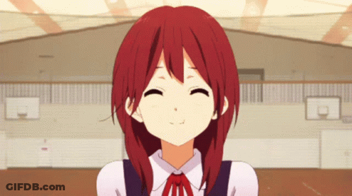 A Girl With Red Hair Is Smiling With A Basketball Court In The Background GIF