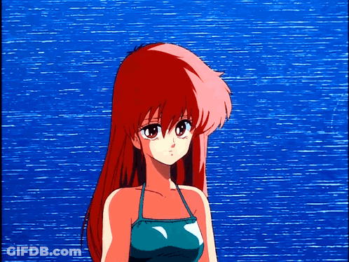 Girl With Red Hair In Front Of Blue Ocean GIF