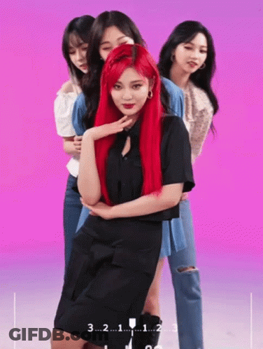 A Girl With Red Hair Is Standing In Front Of A Pink Background With The Number 3 On It GIF
